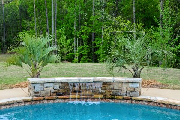 Custom-feature-with-a-waterfall-for-backyard-swimming-pool